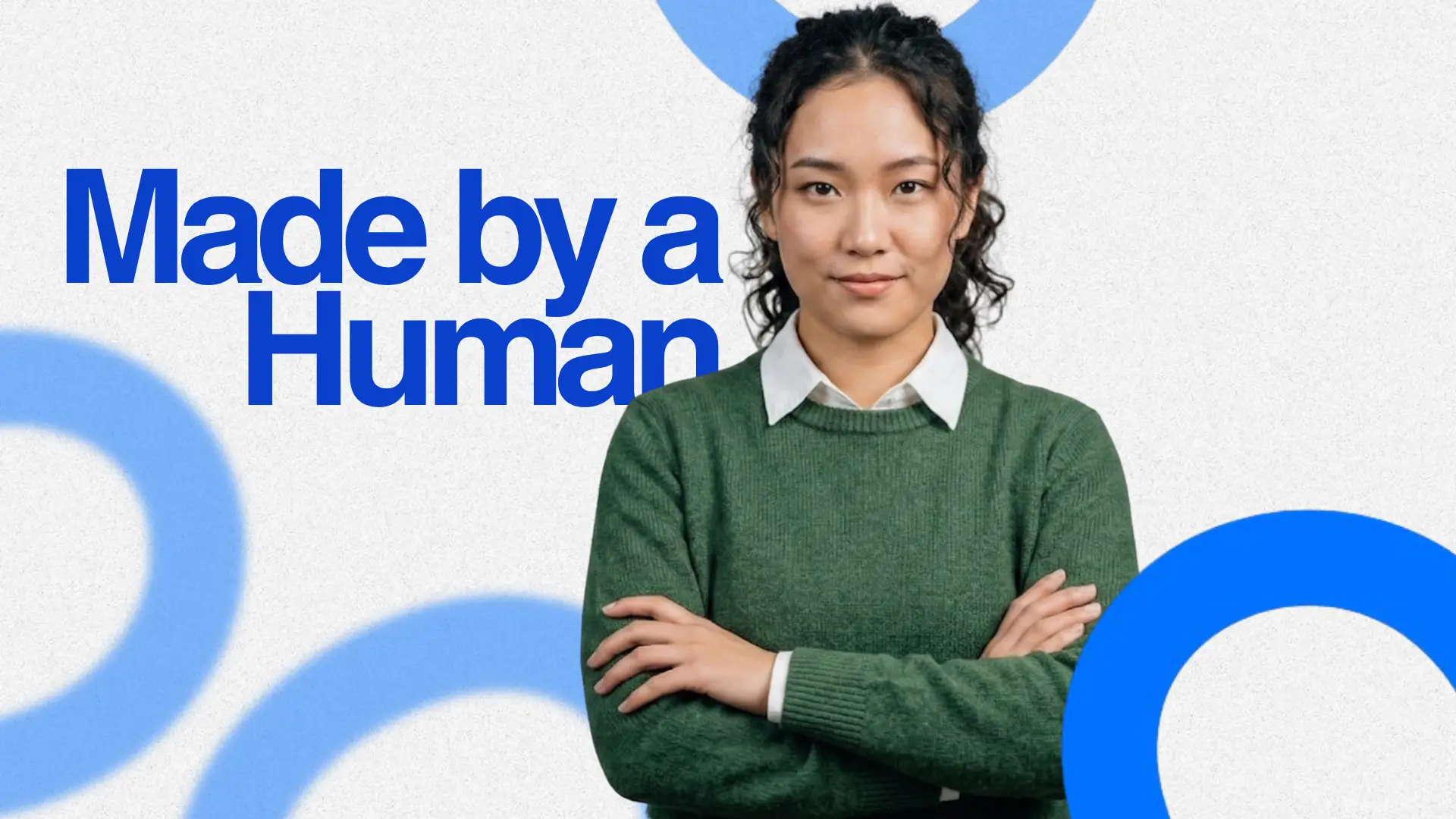 Person in green sweater with arms crossed, standing against gray background with blue circles. Bold text reads “Made by a Human.”